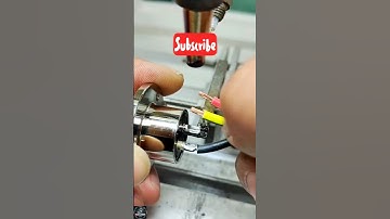 The video displays a close-up view of a manual soldering process using a specialized tool to connect