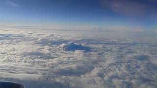 Необычайно красивый вид из окна самолета.  4К. Верхушки гор над облаками.