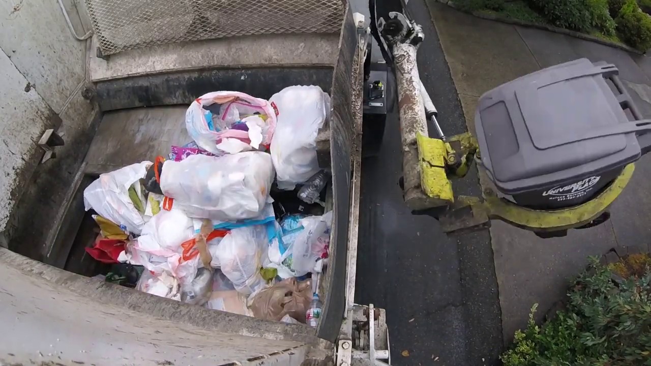 Curbtender packing Trash