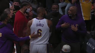 LeBron and Phil Handy screaming at each other while going to the locker room