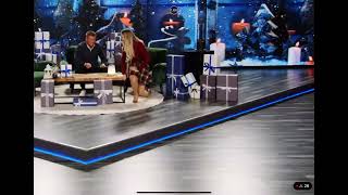 Rebecca Claude Kneeling And Standing To Showcase An Emergency Light