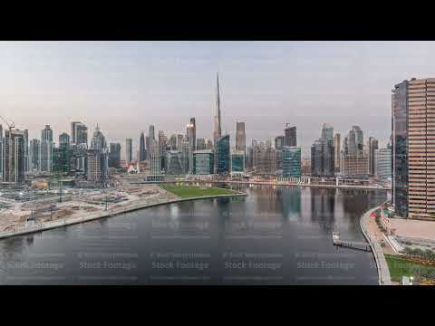 Aerial view to Dubai Business Bay and Downtown with the various skyscrapers and towers day to night