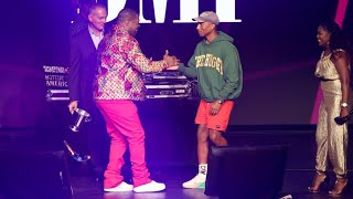 Pharrell gives Busta Rhymes his flowers at the BMI awards