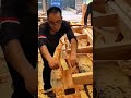 smoothing the surface of large wooden beams with traditional hand plane tool for house construction