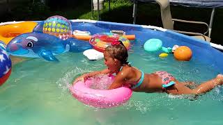 Isabella jumping around pool in slow motion.
