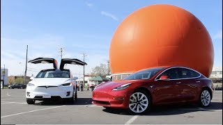 A Tesla Model 3, Model X and a Big Orange