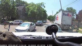Unbelievable moment a runaway FedEx truck rolls down Minnesota street and crashes into a tree