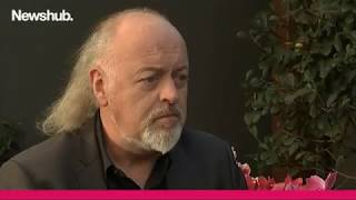 Bill Bailey teaches Newshub reporter paddleboarding technique in unusual interview | Newshub