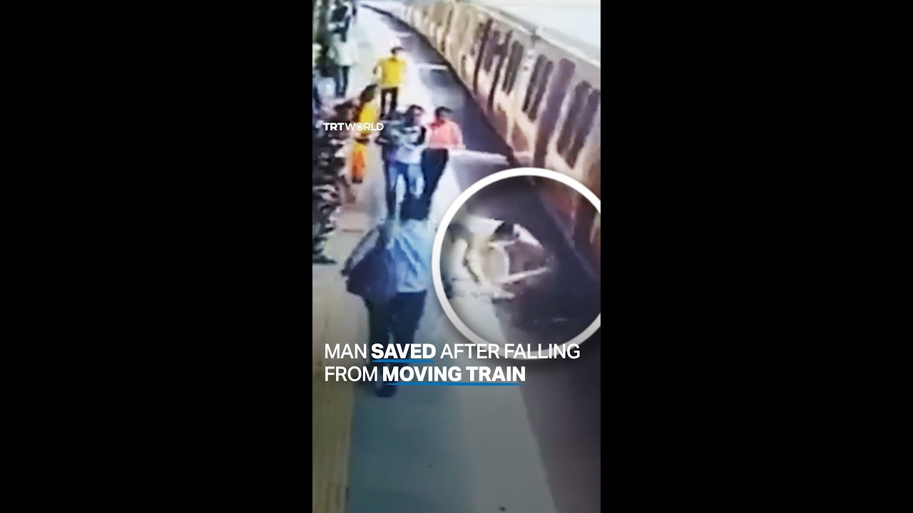 Man slips while attempting to get on train in India