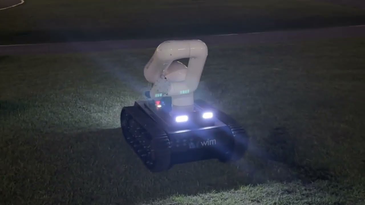 Mobile manipulator on the move: a tracked robot arm outdoors at night