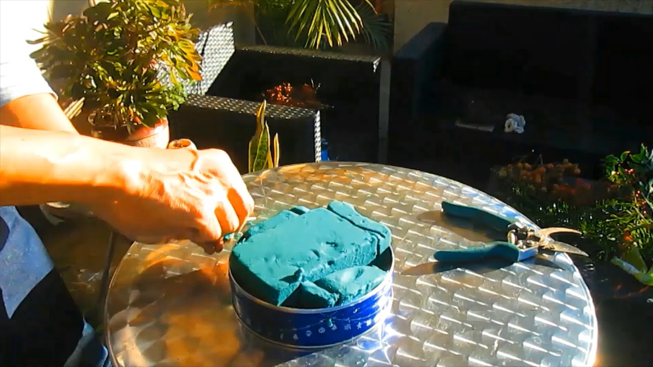 Floral centerpieces on Christmas cookie tin cans