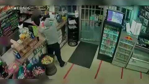 Surveillance video shows cashier turning the tables on armed robber