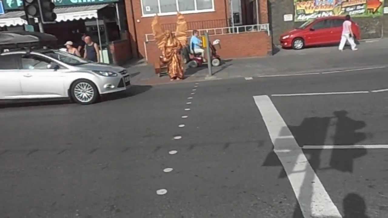 Angel crossing the road in Skegness, Film by me on powerbock stilts