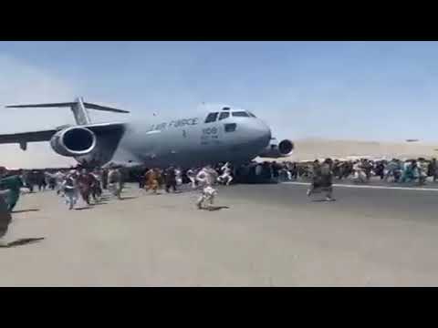 CHAOTIC SCENE: People chase after a plane on a runway at Kabul airport