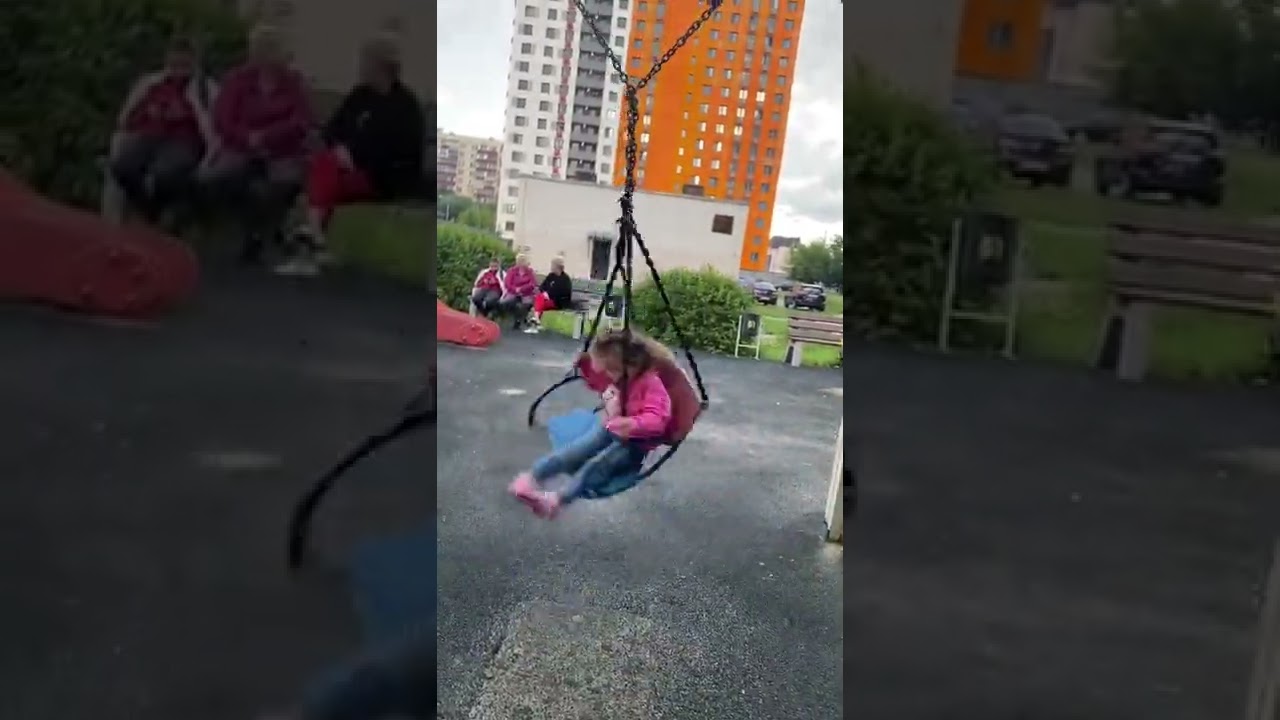 Little girl spinning on the swing 