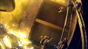 Firefighter catches child thrown from burning apartment during dramatic rescue