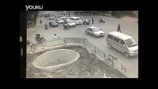 Chinese Motorcyclist Crashes Into Three Vehicles, Drives Into Hole