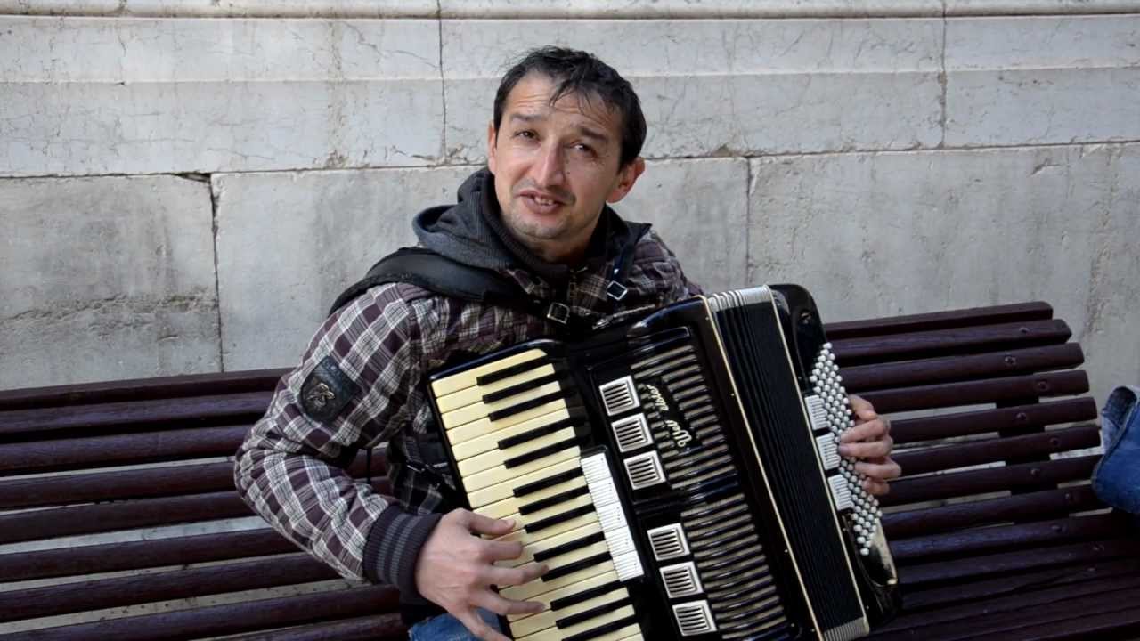 Street artist at Malaga playing Turkish March(Mozart) on accordion ...