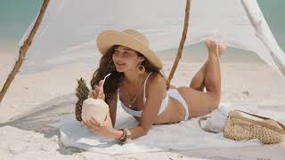 Woman Drinking Coconut Juice While Relaxing On The Beach