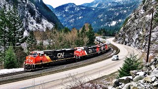 Big Grain Train Snaking Along The Trans-Canada Highway In The Fraser Canyon