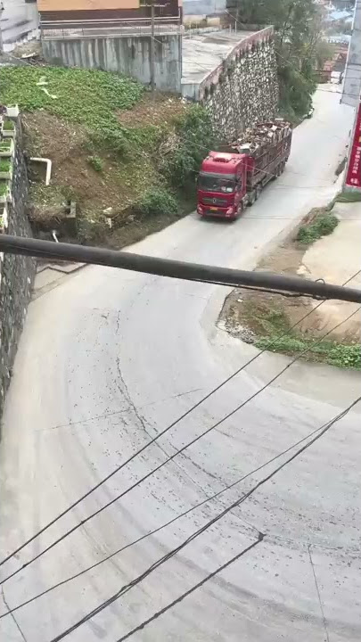 Superb driving skills.The man drives truck through tough bend.