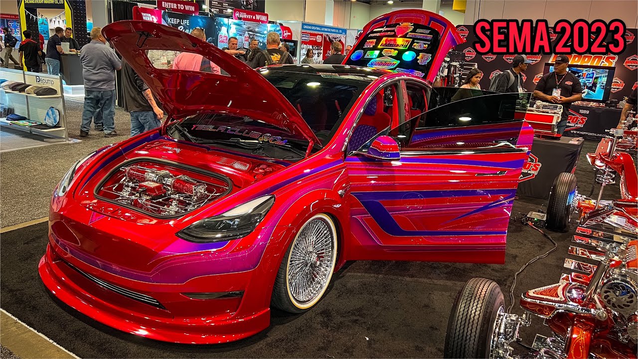 A Lowriderstyle Tesla Y at Hoppo's Custom Suspension Works booth at