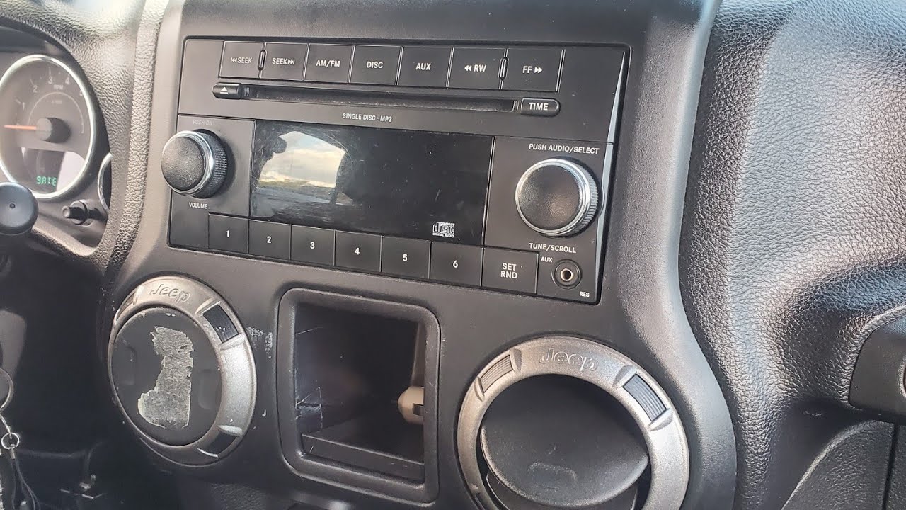 How to: Remove a OEM radio from a 2011 Jeep Wrangler Unlimited - YouTube