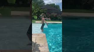 Boy attempts backflip into pool but lands on his back on platform