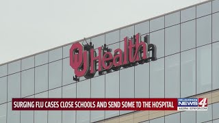 Surging flu cases close schools and send some to the hospital