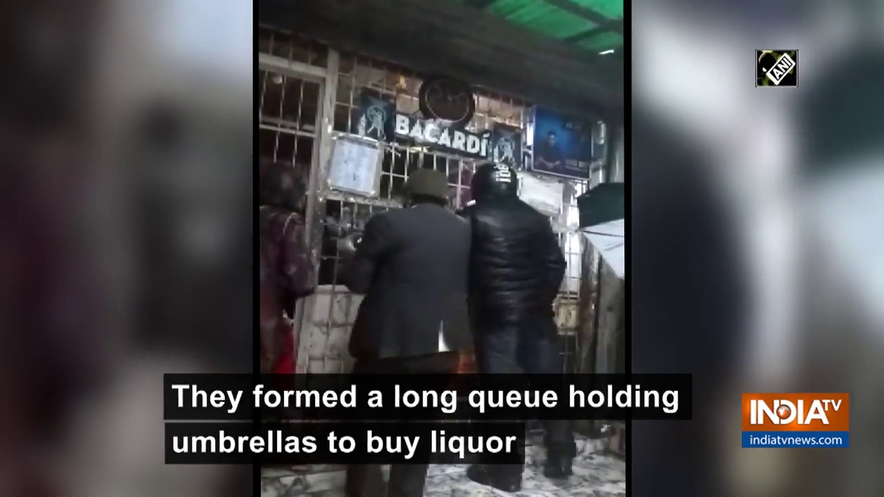 Watch: Alcohol lovers brave hailstorm to buy liquor in Nainital