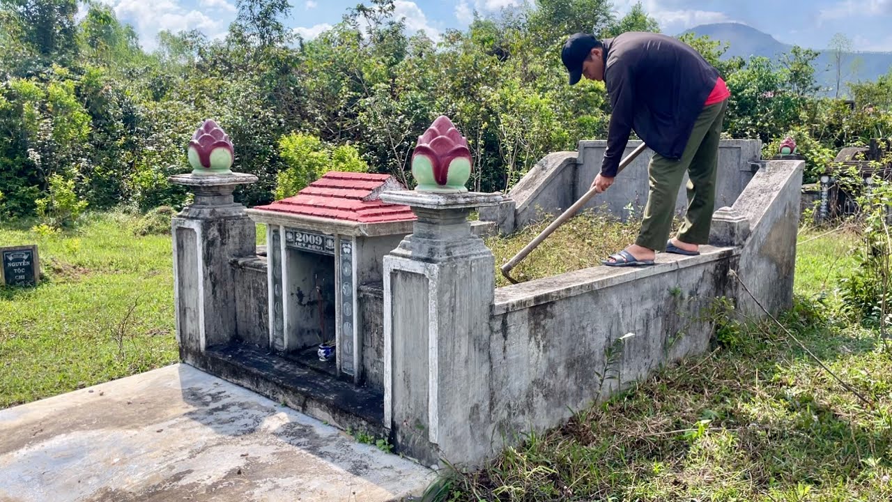 Alone, I cleared the grass from the grave in the midday sun.