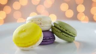 Colorful Macarons In White Plate With Shiny Bokeh Background screenshot 2