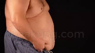 Free Footage - Fat Man Shakes His Fat Belly Against Back Background
