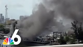 Huge yacht is engulfed in flames as heavy smoke billows from Miami River