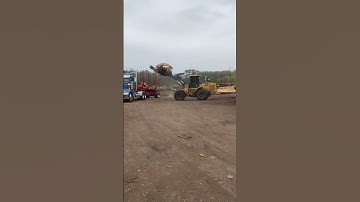 Unloading  logs out the truck deere