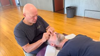 Face and head massage. Naturopath Brandon Raynor massaging Robin.