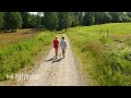 drone shot of two boys walking on small country road in sunny weather