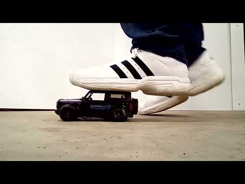Giant Adidas sneakers jumping and stomping on Bronco