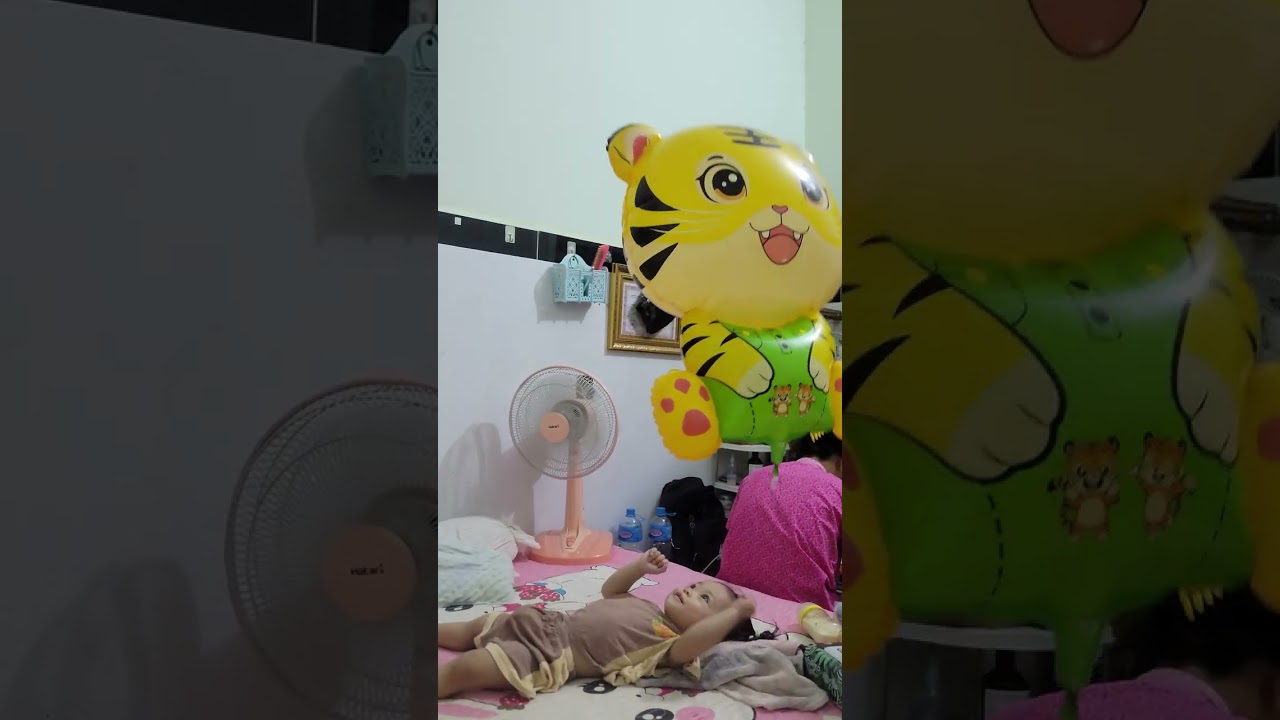 The daughter is playing with balloons.