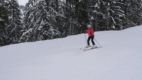 Beginner Skier Carefully Skiing Down The Slope On Skis In The Mountain Resort | Stock Footage -