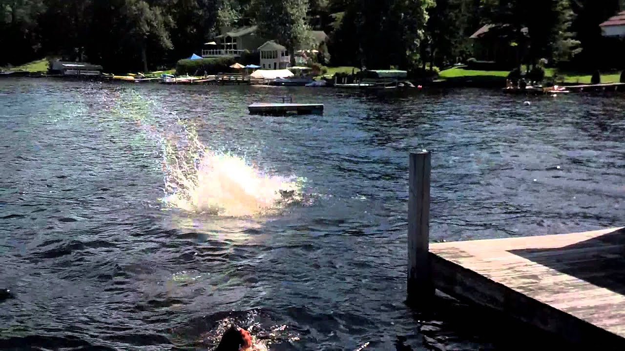 Guy jumping off roof into water