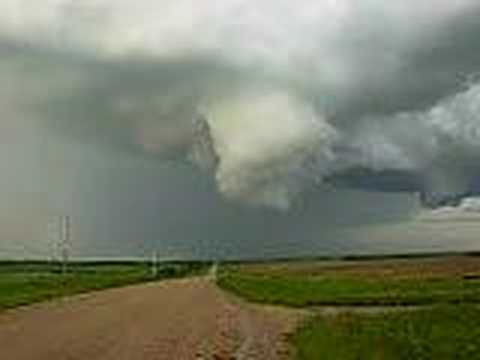 2 wall clouds rotating, i said funnels when filming which was not the case as you can see. However funnel clouds were constantly forming as were other tornadic storms moving NE of Strasbourg, Saskatchewan, Canada. On the other video i have uploaded shows the same storm a few minutes later