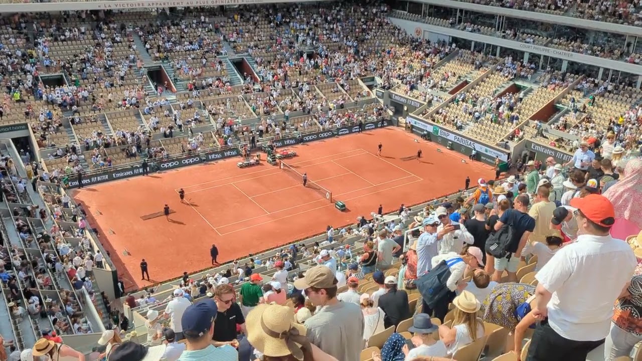 Sweeping a clay tennis court between sets (Roland-Garros Court Philippe-Chatrier)