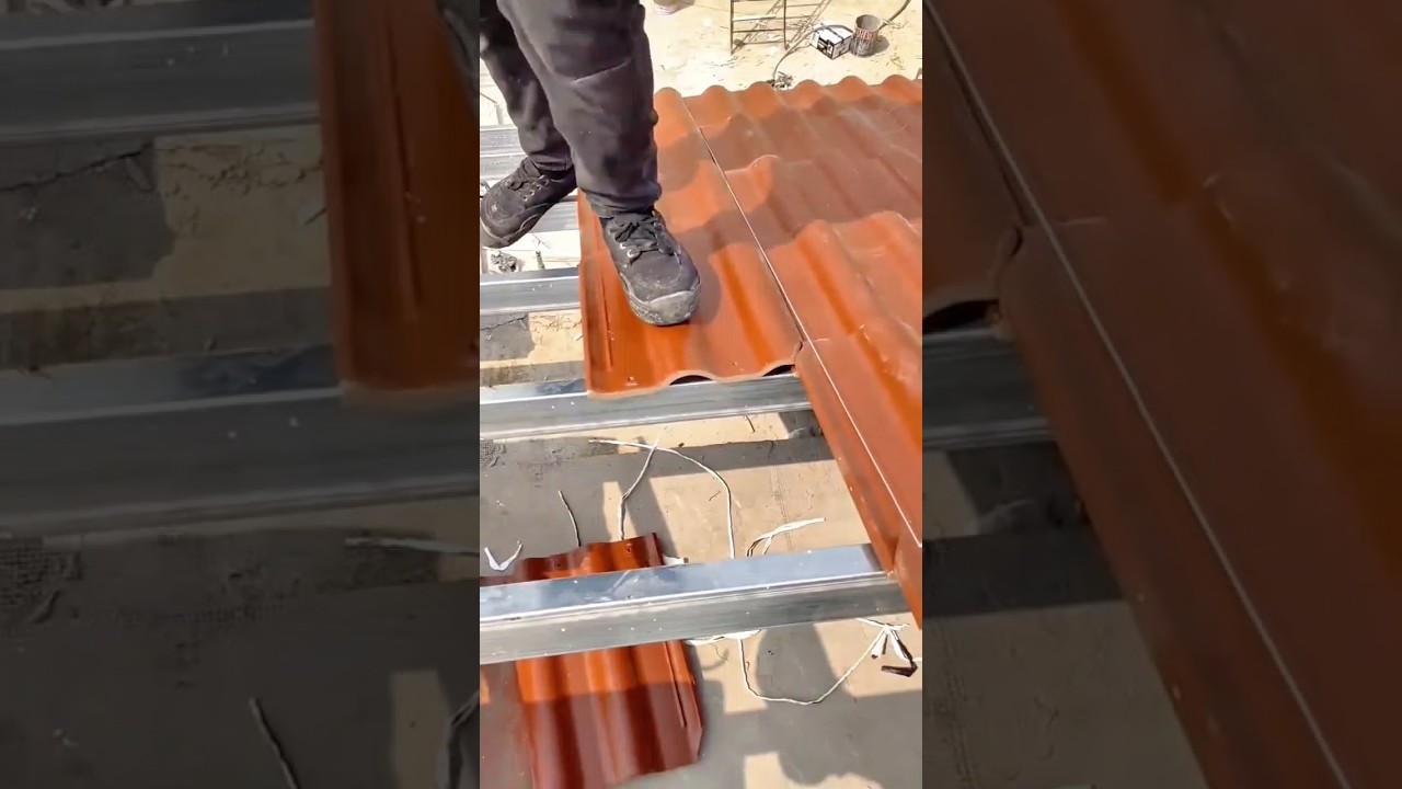 Metal Roofing Installation: Drilling Fasteners to Secure Clay-Colored Corrugated Sheets