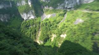 Thicker Waterfall and Earlier Waterfalls Seen Near Rock Shelter Tunnel in Wulong 3 Natural Bridges