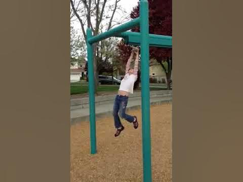 Cathy swinging on monkey bars