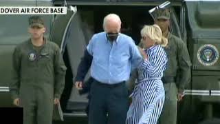 Joe Biden puts on a Jacket