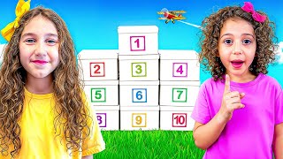 Sierra and Rhia open boxes with surprises to learn the numbers 1-10.