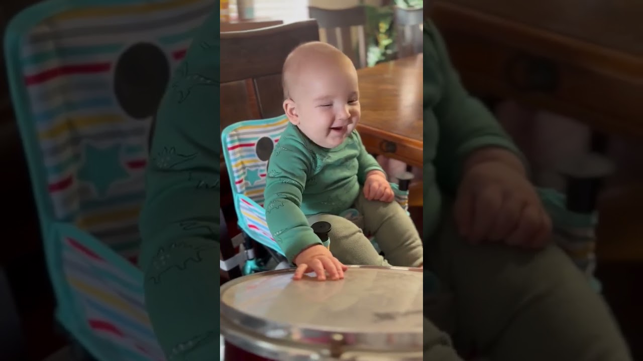 introducing Meatball to the drums. He may be a future drummer!  Too bad I'll be too old to sing then