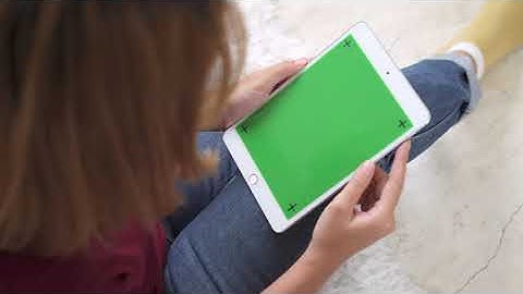 Young Asian Woman Using Black Tablet Device With Green Screen HD